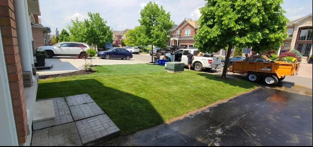 Completed lawn installation with GTA Kentucky Sodding truck visible in driveway