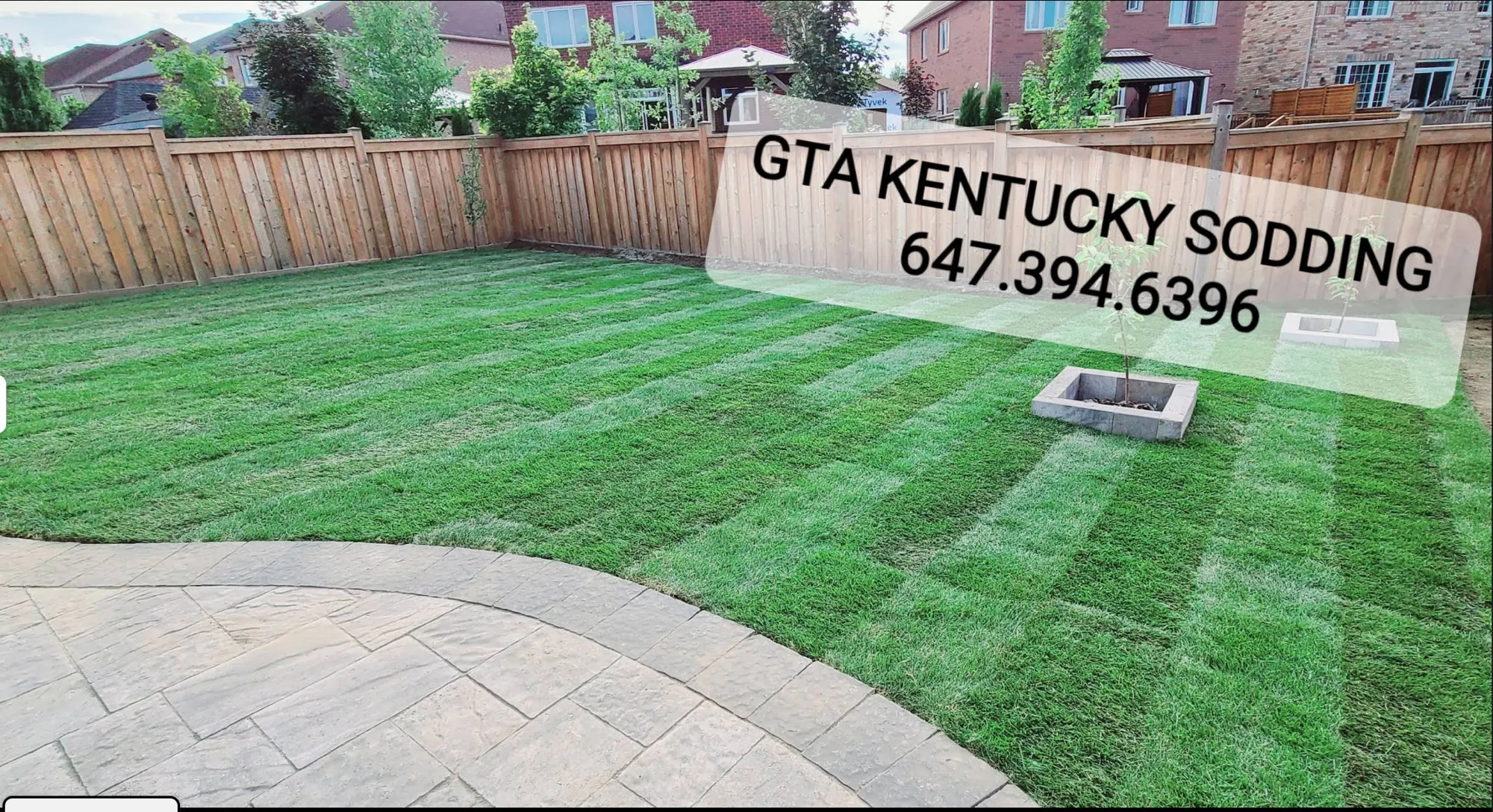Beautiful finished backyard with lush Kentucky bluegrass sod and stone patio by GTA Kentucky Sodding